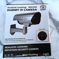 Front view of dummy IR camera packaging showing product image and flashing red LED light feature