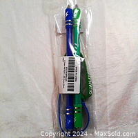 Two fidget pens sealed in clear plastic wrapper, blue and green with wrist straps visible, sealed with barcode label.
