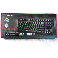 Boxed Xtrike Me GK-979 mechanical gaming keyboard with rainbow backlight and blue mechanical switch branding on black packaging with product image.