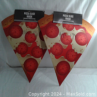 Two foam pizza slice Halloween masks, new with tags, shown flat on white background.