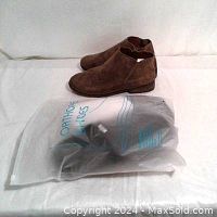 Image showing brown suede ankle boots and orthopedic flip flops sealed in plastic packaging.