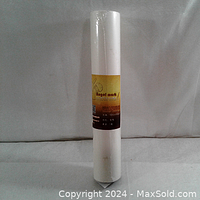 Full view of new sealed roll of Angel Mark pattern paper wrapped in plastic with labeled band.