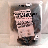 Clear plastic sealed package showing Vicorrect 2-in-1 posture corrector and back brace with product information and barcode label.