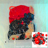 Photo of sealed package containing red and black latex balloons, with red and black confetti balloons visible inside along with packaging warning labels.