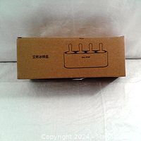 Closed brown cardboard box with printed outline showing 4 popsicle shape slots with handles, labeled 'ICE POP'