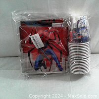 Full view of the sealed Spiderman party kit with napkins, table cover, and cups inside clear plastic packaging.