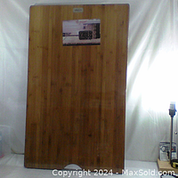 Full view of the XL wood cutting board in its original wrapper with box label attached.