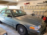 Front driver’s side view of silver sedan in garage