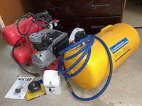 Overall lot view showing compressor, tank, manual, filter and hoses