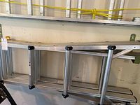 Full view of the mastercraft aluminum ladder propped against the wall showing the rungs and extension mechanism