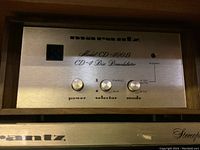 Front view of Marantz Model CD-400B CD-4 Disc Demodulator with control panel and power switch in wood grain cabinet.