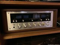Front view showing wood grain cabinet, Marantz logo, four VU meters and control knobs