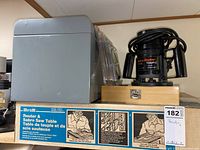 Photo of the Hirsh router and sabre saw table boxed with Black & Decker plunge router and wooden box with bits on top