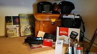 Two Asahi Pentax Spotmatic SLR cameras and associated photography items including camera cases, instructional books, film rolls, and lens filter.