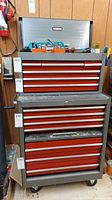 Front view of stacked top toolbox and bottom cabinet with red drawers