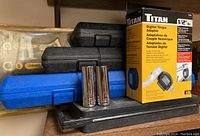 Titan digital torque adapter box with black and blue tool cases and two chrome sockets