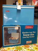 Robins egg blue Coleman cooler on top of original box