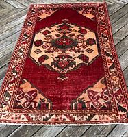 Full view of rug laid flat on deck showing overall pattern and border