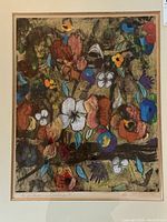 Close-up photo of vibrant abstract floral artwork with flowers in multiple colors on textured background. Signed by Pat McNaughton and titled 'One of a Kind mixed media print' bottom left.