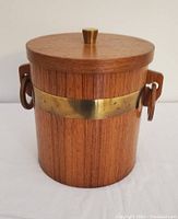 Front view of teak ice bucket with brass band and wooden knob on lid