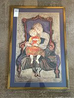 Full view of framed print showing two figures seated on purple chair, framed in gold with purple matting.