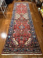 Full view of runner on hardwood floor showing overall pattern, color and condition
