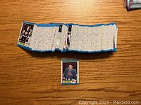 Wide shot of entire 1989-90 OPC hockey card set stacked horizontally, showing thickness and edge colors of cards.