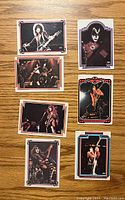 Front sides of seven 1978 Kiss trading cards with full color images of band members.