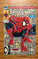 Photo of front cover of Spider-Man #1 comic book, showing Spider-Man crouching on a web foreground, colorful and clear print.