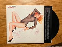 Front view of the Candy-O album cover with the image of a woman reclining on a car.