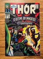Front cover of vintage Thor comic #136 showing dramatic battle scene and comic branding.