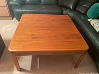 Full top-down view of the square wooden coffee table showing overall shape and condition