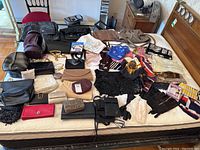 Overview image showing the full assortment of ladies accessories including purses, wallets, gloves, scarves, and bags arranged on a bed