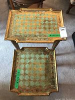 Top view of both nested side tables showing decorative painted trays with geometric pattern and wear