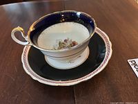 Photo showing the Ansley signed teacup on top of the Grafton saucer with clear view of floral and gold details