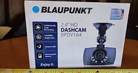 Front view of box showing the product image, brand Blaupunkt, and key features including 2.4" HD screen, continuous loop recording, 120 wide angle lens, infrared light, and rechargeable battery.