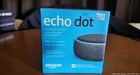 Front of Amazon Echo Dot box showing branding and image of the smart speaker device.