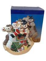 Front view of ceramic Christmas cookie jar with original box in background.