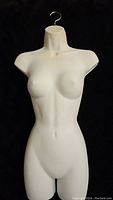 Front view of white female torso mannequin with metal hanging hook, showing defined bust and waist contours.