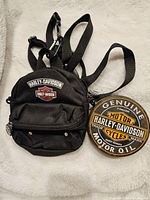 Round Harley Davidson motor oil themed coaster with colorful vintage style logo design.