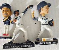 Three Tampa Bay Rays player figures (Matt Garza, Fernando Rodney, Jake Odorizzi) displayed on a surface showing front views and bases with sponsor logos and player names.