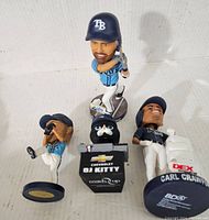 Group view of five Tampa Bay Rays bobbleheads and figures showing Carl Crawford figure, batter, pitcher, and two DJ Kitty mascot figures