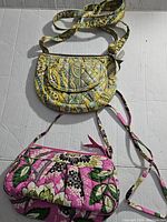 Both Vera Bradley purses shown together on light background, highlighting size, pattern and condition