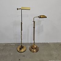 Both lamps side by side on concrete floor against white wall