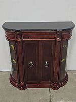 Front view of the solid wood console cabinet with marble top, closed doors, and curved glass panels on each side