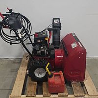Side-left view of snow blower with gas can on pallet