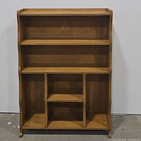 Front view of wooden display hutch showing shelves and divided compartments