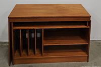 Teak entertainment center with front view showing fixed and sliding design for expansion and shelving compartments.