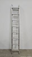 Full view of a 16-foot aluminum extension ladder showing its height and basic design.