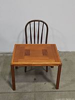 Wooden kids table with wood inlay top and straight legs shown from above and front angle.
